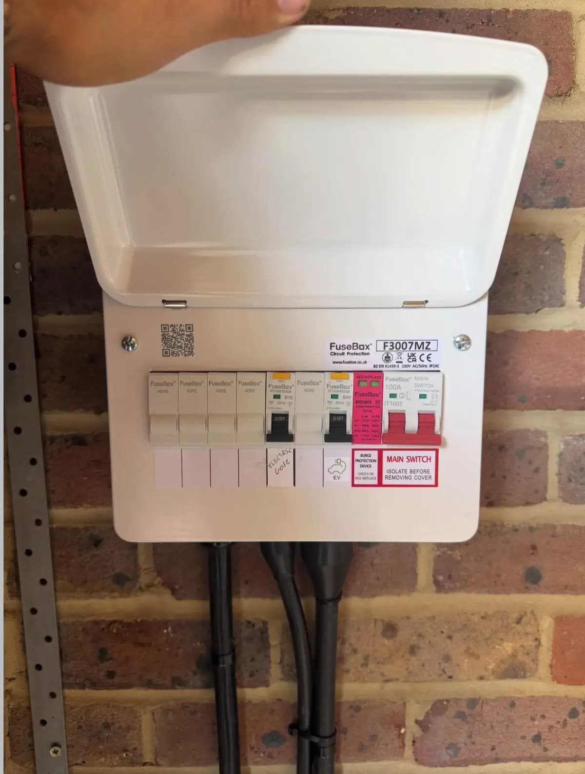 New consumer unit installed on an outside brick wall in Reigate to supply the EV charger